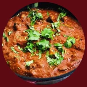 Special Tikka Masala served in a copper bowl, garnished with fresh cilantro and paired with naan bread