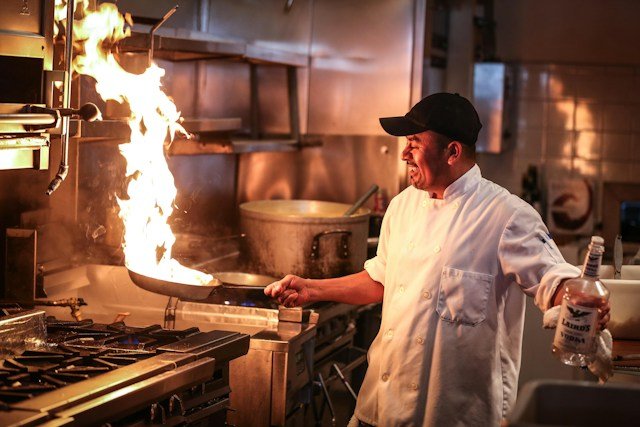 Professional cook making kebab food near me on stove..Okotoks restaurant
