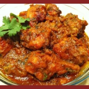 Chicken cooked with caramelized onions and spices, garnished with coriander in a thick curry